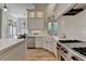 Bright kitchen with white cabinetry, stainless steel appliances, farmhouse sink and breakfast nook at 4505 Whitestone Way, Suwanee, GA 30024