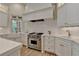 Modern kitchen featuring stainless steel appliances, white countertops, and farmhouse sink at 4505 Whitestone Way, Suwanee, GA 30024