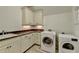 Functional laundry room with washer, dryer, sink and storage at 4505 Whitestone Way, Suwanee, GA 30024