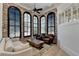 Cozy living room with brick walls, large windows, and comfortable seating area at 4505 Whitestone Way, Suwanee, GA 30024