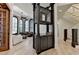 Elegant living area featuring brick walls, custom bar, and views of staircase at 4505 Whitestone Way, Suwanee, GA 30024