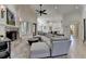 Spacious living area showcasing a brick fireplace, large sectional sofa, and seamless flow to kitchen at 4505 Whitestone Way, Suwanee, GA 30024