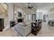 Open-concept living room featuring a brick fireplace, hardwood floors, and a view into the kitchen at 4505 Whitestone Way, Suwanee, GA 30024