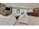 Bright living room with stone fireplace, open floor plan, and a full bar at 4505 Whitestone Way, Suwanee, GA 30024
