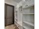 Mudroom with white cabinets and built-in bench near a dark wood door at 4505 Whitestone Way, Suwanee, GA 30024