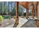 Inviting stone patio with a wood-burning fireplace and comfortable Adirondack chairs overlooking a private backyard at 4505 Whitestone Way, Suwanee, GA 30024