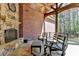 Covered patio with a stone fireplace and views of the backyard at 4505 Whitestone Way, Suwanee, GA 30024