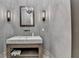 Stylish powder room featuring a stone countertop and rustic wood vanity at 4505 Whitestone Way, Suwanee, GA 30024