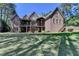 Stunning brick home with a spacious yard, covered balconies, and a walkout basement at 4505 Whitestone Way, Suwanee, GA 30024
