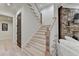 Staircase leading to a living area featuring a stone fireplace and mantle at 4505 Whitestone Way, Suwanee, GA 30024