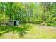 Expansive backyard view showing lush greenery and a shed at 8211 Thompson St, Douglasville, GA 30134