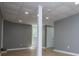 Large basement with a drop ceiling, access to the outside and another room at 8211 Thompson St, Douglasville, GA 30134