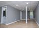 Large open basement with drop ceiling, modern vinyl flooring and lots of potential at 8211 Thompson St, Douglasville, GA 30134