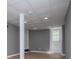 Finished basement with recessed lighting, neutral paint, and a door to the backyard at 8211 Thompson St, Douglasville, GA 30134