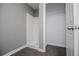Bathroom features a shower and closet with gray walls and hardwood floors at 8211 Thompson St, Douglasville, GA 30134