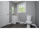 Updated bathroom with modern vanity, neutral walls, and wood-look flooring at 8211 Thompson St, Douglasville, GA 30134