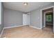 A spacious bedroom with light hardwood floors and gray walls at 8211 Thompson St, Douglasville, GA 30134