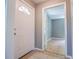 The entryway boasts tile flooring and opens to a hallway with bright hardwood flooring at 8211 Thompson St, Douglasville, GA 30134