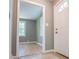 Inviting entryway with neutral paint, light floors, and a glimpse into a sunlit living space at 8211 Thompson St, Douglasville, GA 30134