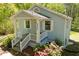 Charming one story home exterior with landscaped yard, covered porch and number above the door at 8211 Thompson St, Douglasville, GA 30134
