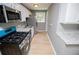Gray kitchen with white cabinets, granite countertop, and stainless steel appliances at 8211 Thompson St, Douglasville, GA 30134
