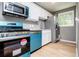 Modern kitchen features granite countertops, stainless steel appliances, and wood-look floors at 8211 Thompson St, Douglasville, GA 30134