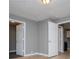 Open living space with multiple doorways, neutral walls, and wood-look flooring at 8211 Thompson St, Douglasville, GA 30134