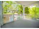 Spacious front porch offering an elevated view, featuring white railings and a glimpse of the nearby landscape and home at 8211 Thompson St, Douglasville, GA 30134