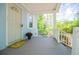 Welcoming front porch view with white railings, light blue siding, and a decorative 'hello' mat by the entrance at 8211 Thompson St, Douglasville, GA 30134