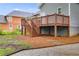 Exterior features a covered wooden deck with stairs, concrete driveway and lush lawn at 926 Welch Sw St, Atlanta, GA 30310