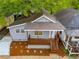 Charming home boasts a covered porch, fresh landscaping, and neutral siding at 926 Welch Sw St, Atlanta, GA 30310