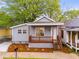 Charming home featuring a cozy front porch, freshly landscaped yard, and attractive gray siding at 926 Welch Sw St, Atlanta, GA 30310