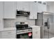 Modern kitchen featuring stainless steel appliances, white cabinetry and marble tile backsplash at 926 Welch Sw St, Atlanta, GA 30310