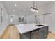 Modern kitchen with island, stainless steel dishwasher, and white cabinets at 926 Welch Sw St, Atlanta, GA 30310