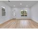 Bright living room showcasing recessed lighting, a decorative front door, and hardwood floors at 926 Welch Sw St, Atlanta, GA 30310