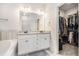 Bathroom with double sink vanity, granite counters, and walk-in closet for ample storage at 1195 Awenasa Dr, Villa Rica, GA 30180