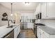 Modern kitchen featuring granite countertops, stainless steel appliances, and white cabinets at 1195 Awenasa Dr, Villa Rica, GA 30180