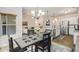 Charming dining area with a view to the kitchen with stainless steel appliances and white cabinets at 1195 Awenasa Dr, Villa Rica, GA 30180