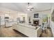 Open concept living room with a brick fireplace, hardwood floors, kitchen and dining areas at 1195 Awenasa Dr, Villa Rica, GA 30180