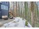 The backyard features a comfortable seating area with a patio, ideal for relaxing outdoors amidst tall trees at 3214 Cedar Bluff Ne Dr, Marietta, GA 30062