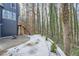 A cozy backyard with a patio and wooden stairs leading to the upper level, surrounded by tall trees at 3214 Cedar Bluff Ne Dr, Marietta, GA 30062