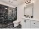 Modern bathroom featuring a sleek shower with black marble-style tile and a vanity at 3214 Cedar Bluff Ne Dr, Marietta, GA 30062