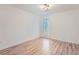 Bright bedroom featuring wood-look floors, a window, and modern ceiling light at 3214 Cedar Bluff Ne Dr, Marietta, GA 30062