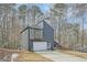 Unique home with modern design with large windows and garage door on a large lot surrounded by trees at 3214 Cedar Bluff Ne Dr, Marietta, GA 30062