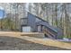 Unique exterior elevation showcases creative architecture with wooden stairs and a modern garage door with minimalist window design at 3214 Cedar Bluff Ne Dr, Marietta, GA 30062