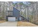 Striking modern exterior with a unique architectural design and a two-car garage with an extra upper bay window at 3214 Cedar Bluff Ne Dr, Marietta, GA 30062
