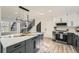 Bright modern kitchen features a large center island with a waterfall countertop and stainless steel appliances at 3214 Cedar Bluff Ne Dr, Marietta, GA 30062