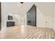 Open-concept living area with a fireplace, bar area, and modern lighting fixtures at 3214 Cedar Bluff Ne Dr, Marietta, GA 30062