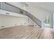 Bright, open living area featuring modern staircase, wood floors, and abundant natural light at 3214 Cedar Bluff Ne Dr, Marietta, GA 30062