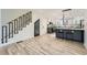 Spacious open-concept living area and kitchen featuring stylish wood floors, a central island, and modern lighting at 3214 Cedar Bluff Ne Dr, Marietta, GA 30062